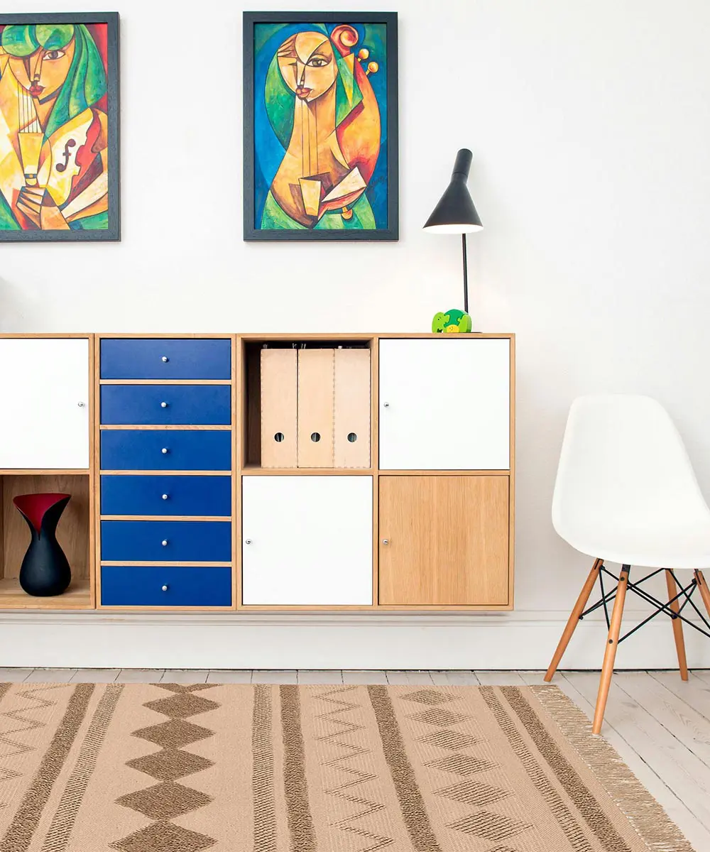 Tappeto berbero Bbiege in cotone con geometrie marocchine in rilievo, colori avorio e sabbia, su pavimento chiaro con divano e tavolino dorato