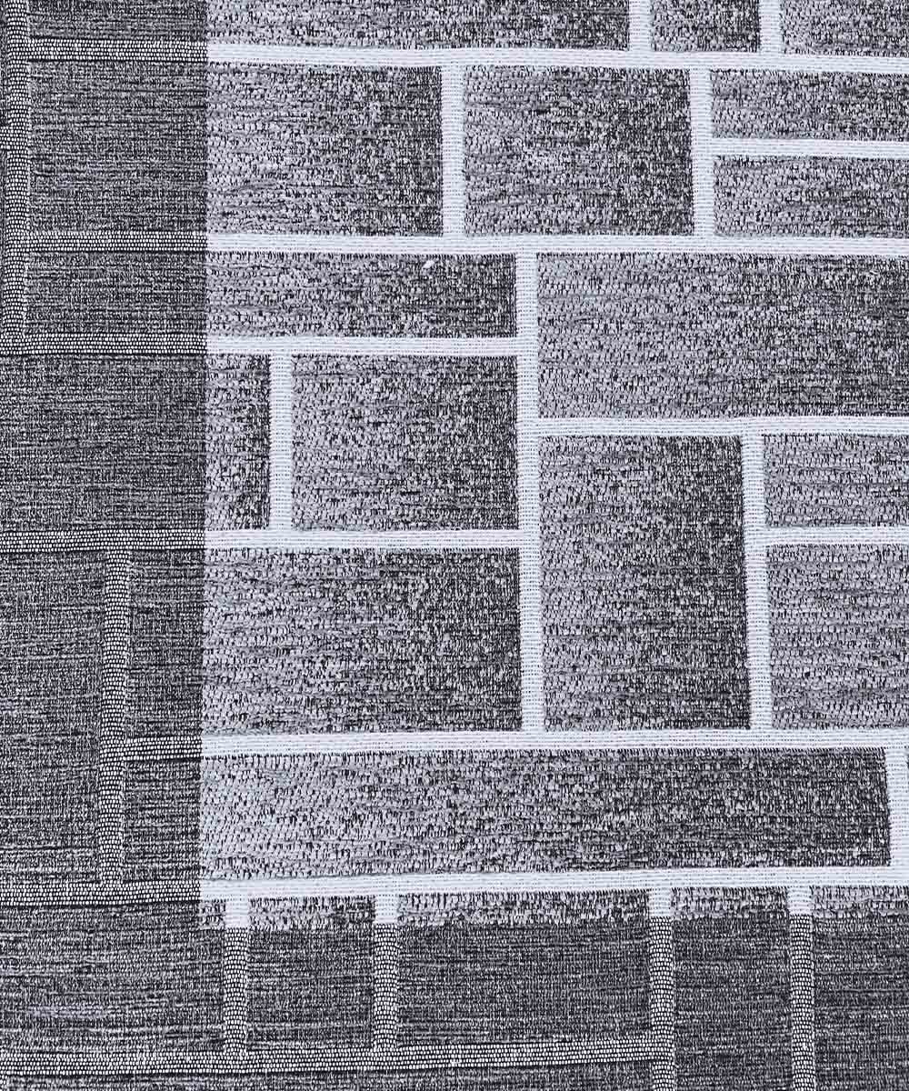 Dettaglio della trama in chenille del tappeto Domino Grigio con disegno geometrico grigio e filetti bianchi